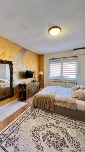 a bedroom with a large bed and a mirror at Guest House Bosnian House in Sarajevo