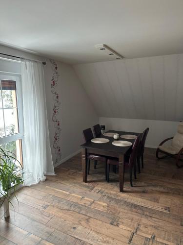 a dining room with a table and chairs at Am Oberpark in Bad Muskau