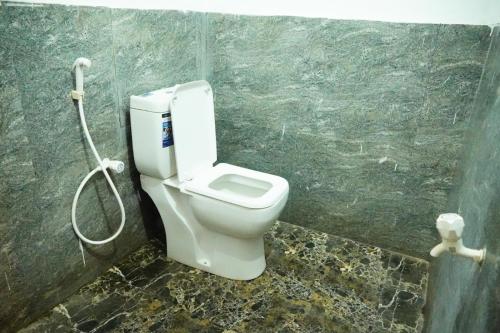 a bathroom with a toilet and a shower at Beach View Resort in Batticaloa