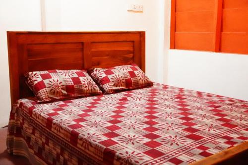 a bed with two pillows on it in a room at Beach View Resort in Batticaloa