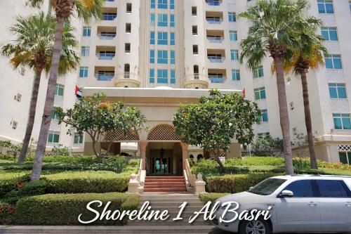 a car parked in front of a building at Bright 2 Bedroom Apartment, Beach & Pool Access in Dubai