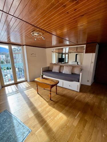 a bedroom with a bed and a table in a room at Face au chateau in Vizille