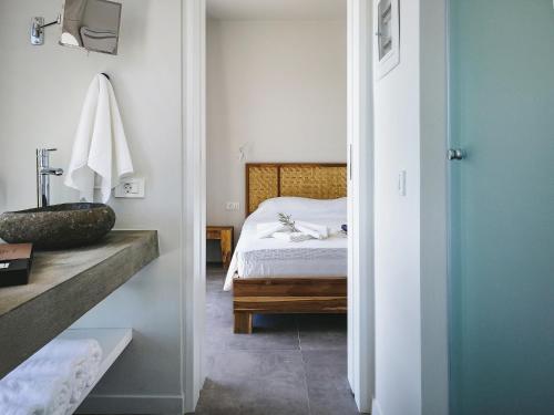 a bedroom with a bed and a bathroom at Villa Helena in Paleros