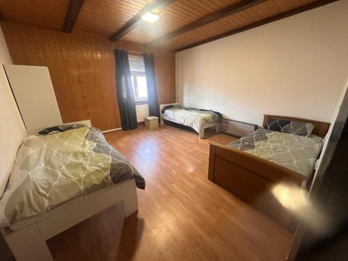 an empty room with two beds and a window at Monteurunterkunft nahe Tor 1 in Leuna