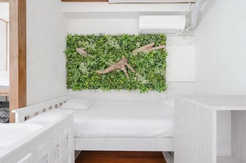 a bedroom with a wall covered in ivy at Large Private House for 18 Tokyo Tower JR Hamamatsucho 8min HOTEL Musashi Tokyo Shiba in Tokyo