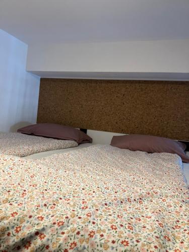 a bed with a head board and pillows on it at Apartament Kołobrzeska in Piła