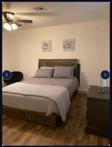 a bedroom with a bed and a ceiling fan at Heavenly Home in Monroe
