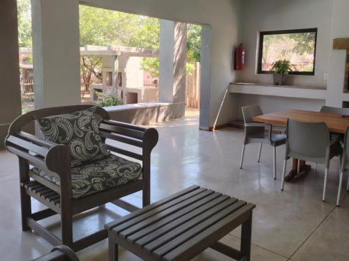 a living room with a bench and a wooden table at The Lofts in Hoedspruit