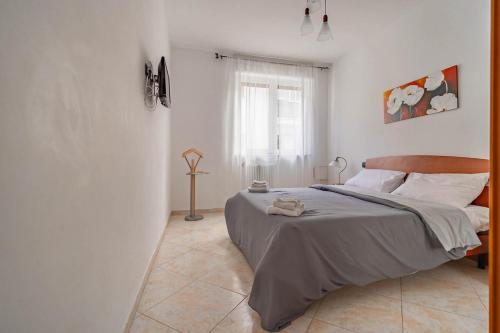 a bedroom with a large bed in a white room at Casetta Di Denny in Polignano a Mare