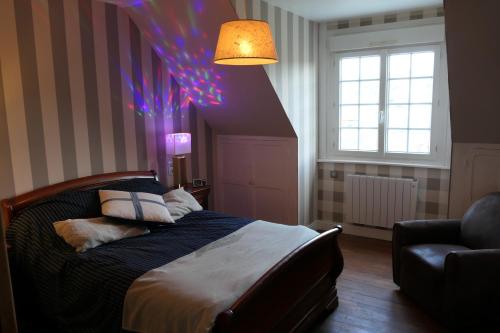 a bedroom with a bed with a purple ceiling at La Maison d'Adonis à la mer in Crozon