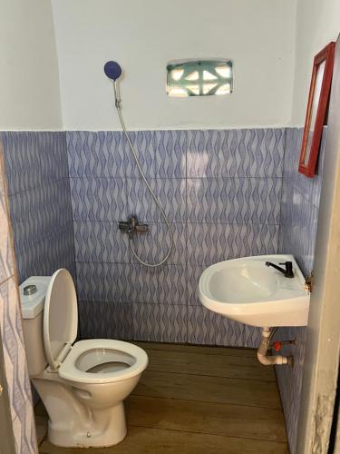 a bathroom with a toilet and a sink at O'Sole Mio Assinie - La résidence in Assinie