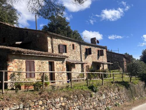 an old stone building on the side of a road at LA GRANCIA DEL SANTO in Monticiano