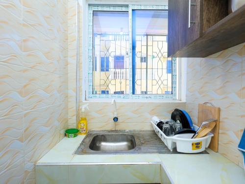 a kitchen with a sink and a window at Heavenly homes apartment in Mombasa