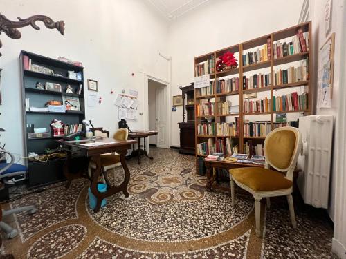 a room with two desks and shelves with books at Hostello Genovese in Genoa