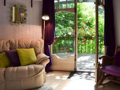 a living room with a couch and an open door at Beach Retreat - Ukc2322 in St Ives