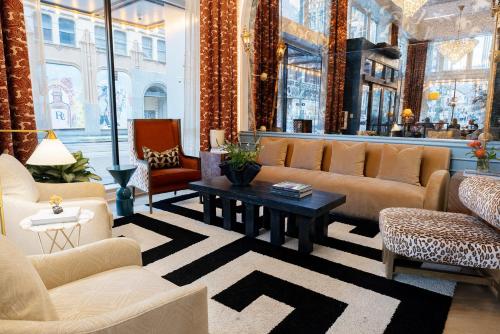 a living room with couches and a coffee table at voco Hotel Napoleon Memphis by IHG in Memphis