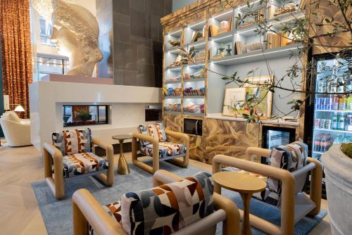 a waiting room with chairs and a fireplace at voco Hotel Napoleon Memphis by IHG in Memphis