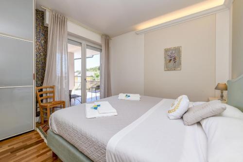 a bedroom with a bed with two towels on it at Villa Caterina in Salò