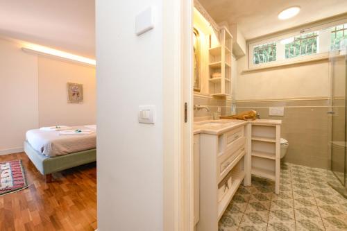 a bathroom with a sink and a bed in a room at Villa Caterina in Salò
