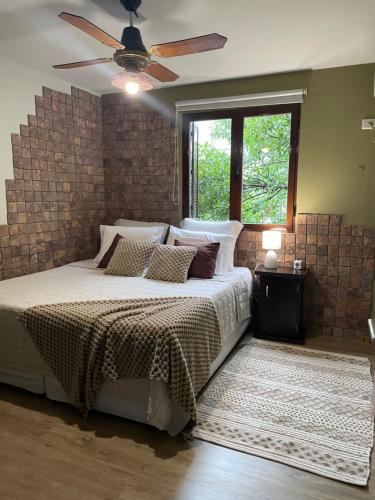 a bedroom with a bed and a ceiling fan at Lysa Paraná in Paraná