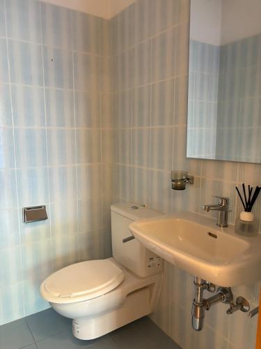 a bathroom with a toilet and a sink at the Lake View apartment in Mendrisio