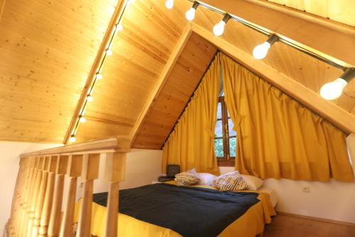 a bedroom with a bed in a room with wooden ceilings at Love Corner in Batumi
