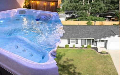 a large swimming pool in the backyard of a house at Private Ranch- Entire Home - Hot Tub - Pets & Kids Welcome - King Bed - Fenced Backyard - Free WiFi in Gahanna