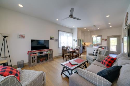 a living room with couches and a tv and a kitchen at Bozeman Home with Deck Walk to Fishing, Hot Springs in Bozeman