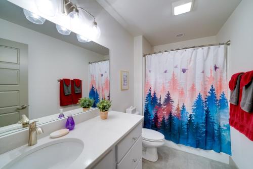 a bathroom with a toilet and a shower curtain at Bozeman Home with Deck Walk to Fishing, Hot Springs in Bozeman