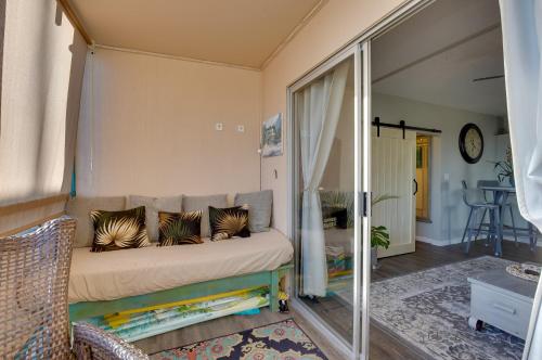 a living room with a couch with pillows on it at Lanai & Community Pool Access: Sunny Central Condo in Kailua-Kona