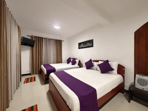 a hotel room with two beds and a tv at Sylvan Crest Ella in Ella