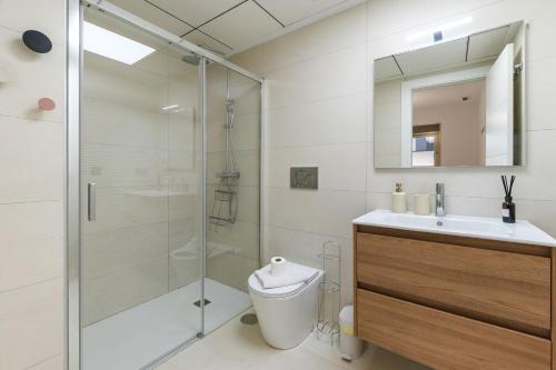 a bathroom with a shower and a toilet and a sink at He Musica in Torrevieja