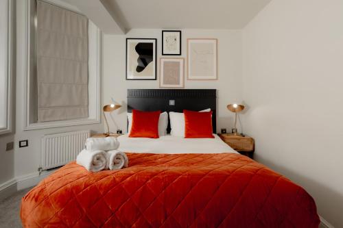 a bedroom with a bed with two dogs on it at Kensington House Hotel in London