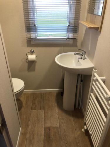 a bathroom with a sink and a toilet at Dunes Escape in Lossiemouth