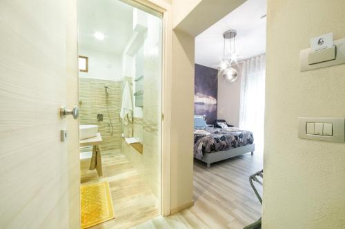 a door leading to a bedroom with a bed at Tzia Lillina B&B in Iglesias