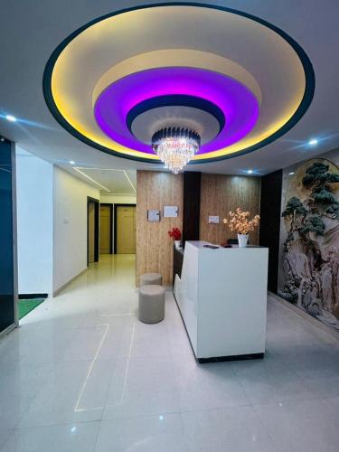 a lobby with a purple ceiling in a building at Hotel Kunj Bihari in Lucknow