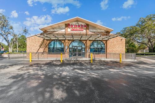 a building with a sign on the front of it at Ramada by Wyndham Temple Terrace/Tampa North in Tampa