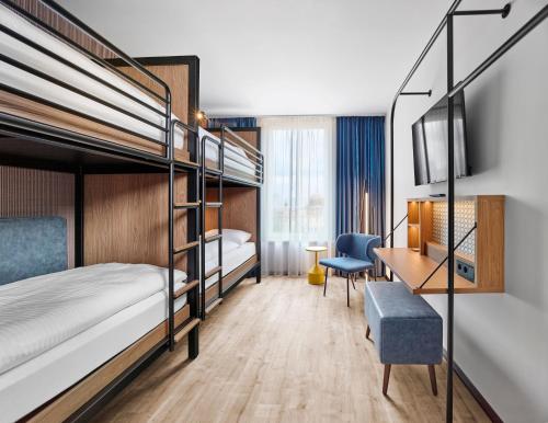 a hotel room with bunk beds and a desk at H2 Hotel Erfurt in Erfurt