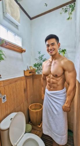 a man standing in a bathroom with a toilet at Hanki Guest House syariah in Gadok 1