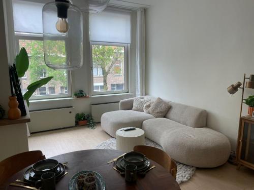 a living room with a couch and a table at 'Lima' Luxe appartement in Vlissingen in Vlissingen