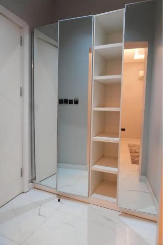 a wardrobe with glass doors in a room at 2020 Apartment Guzape in Chini