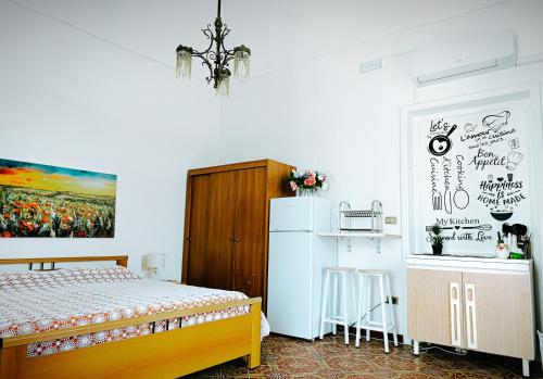 a bedroom with a bed and a refrigerator at Le volte di Umberto Scirocco in Sogliano Cavour