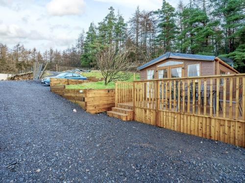 a wooden fence in front of a house at The Orchard - Uk7111 in Alloa