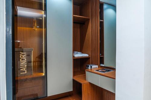 a dressing room with a glass door and a mirror at Aurum on Missouri in Abuja