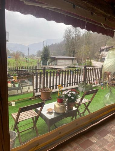 a window with two chairs and a table with potted plants at Casa Gallo Music Room in Lamon