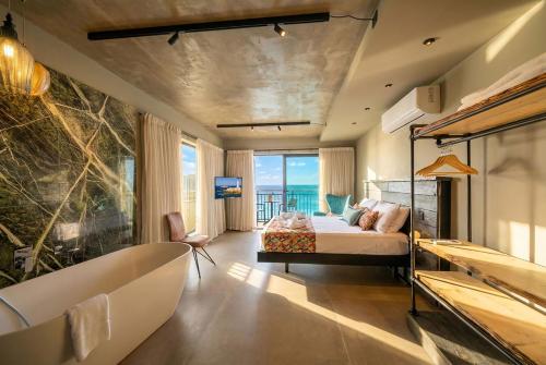 a bedroom with a bed and a view of the ocean at Del Mar Court in Marsalforn