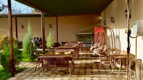 a patio with a bunch of chairs and tables at Tashkent apart hotel in Tashkent