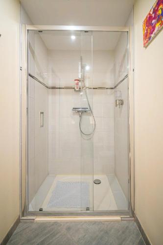 a shower with a glass door in a bathroom at Au nid d'Alsace - SPA et sauna privé in Orschwiller