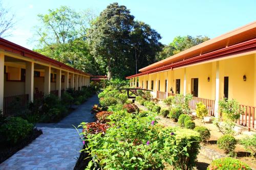 a courtyard of a building with a row of plants at La Foresta Nature Resort in Quepos