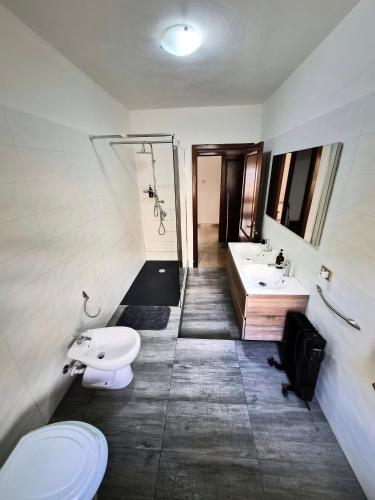 a bathroom with a toilet and a sink at House Riky in Assemini